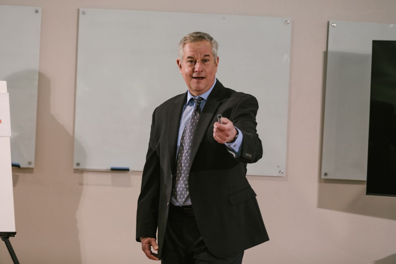 Professional presenter delivering a business talk in a conference room.